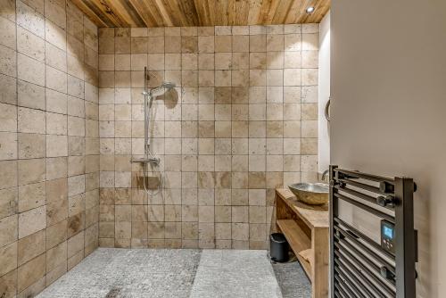 a bathroom with a shower and a sink at Appartement FORNET à l'Hôtel LE VAL D'ISERE in Val dʼIsère