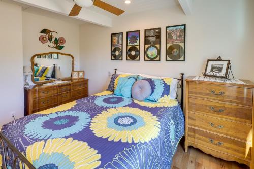 a bedroom with a blue and yellow bed and a dresser at Home with Views and Fire Pit, 10 Mi to Aztec Ruins! in Farmington
