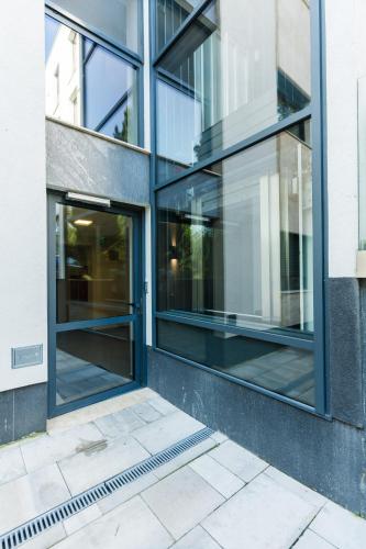 an entrance to a building with glass windows at Club Panorama Lake View Apartment in Alsóörs