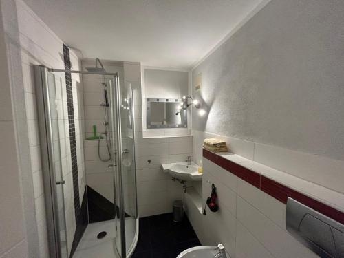 a bathroom with a shower and a sink at Fewo Ferienpark mit Swimmingpool und Aussicht 15 in Missen-Wilhams