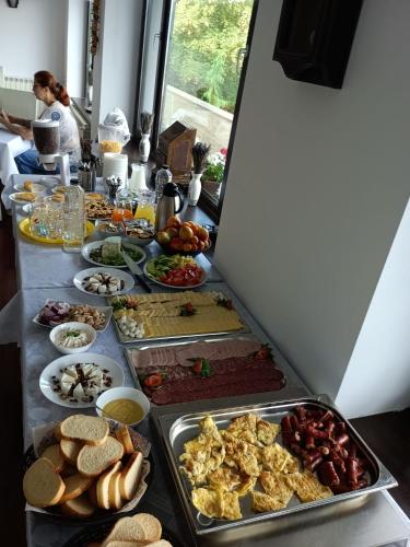 a table with many different types of food on it at Belvedere Resort Moieciu in Moieciu de Jos