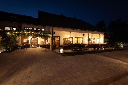 a building with tables and chairs at night at Penzion Pibernik in Bled