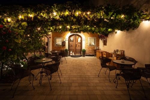 a patio with tables and chairs in a building at Penzion Pibernik in Bled