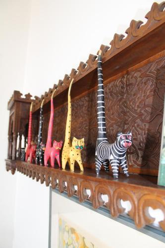 a shelf with many figurines of animals on it at Dancing Iguanas in Eagle Beach