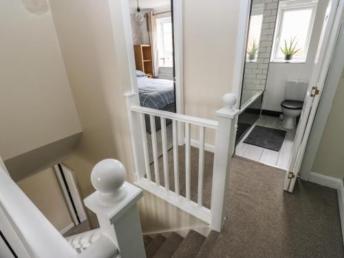 a staircase leading to a bedroom and a bathroom at Fisherman's Retreat in Mirfield