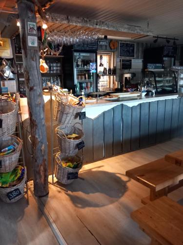 a bar with baskets of food and a counter at Sevetin Baari & Guesthouse in Sevettijärvi