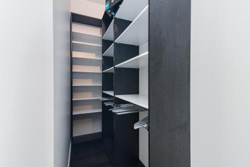 a walk in closet with black and white shelves at Le Se7t Penthouses in Montréal