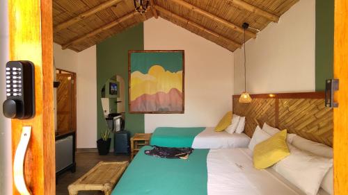 a bedroom with two beds and a table in it at Puerto Bamboo in Máncora