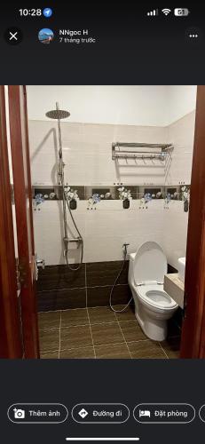 a bathroom with a toilet and a shower stall at Hotel Đại Dương in Thuan An