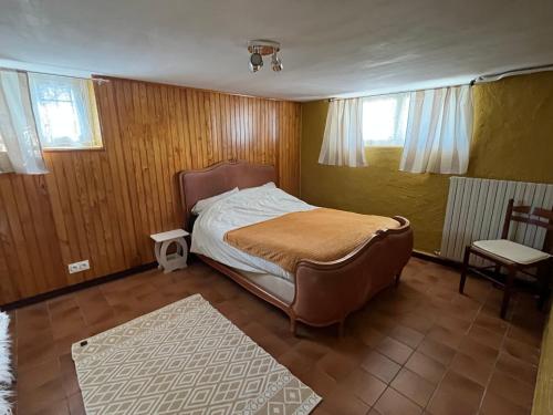 a small bedroom with a bed and a chair at Camping Cote de Chevre 