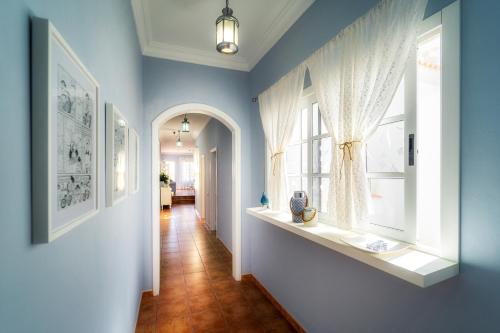 a blue room with a window and a hallway at Atlantic View La Caleta Adeje in Adeje