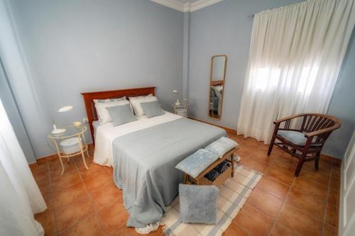 a bedroom with a large bed and a chair at Atlantic View La Caleta Adeje in Adeje