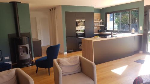 a living room with a kitchen with a stove at Cozy and welcoming, Pretty quiet holiday home, Crozon peninsula, Camaret-sur-mer in Camaret-sur-Mer
