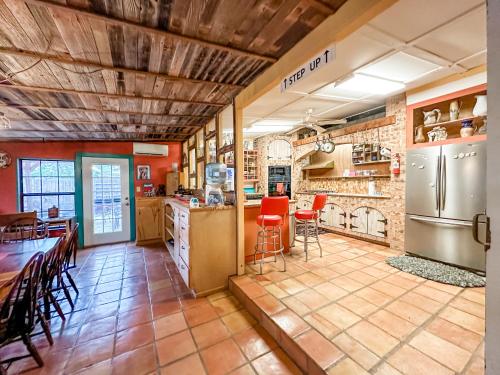a large kitchen with a table and a refrigerator at Inn at the Art Center in San Angelo