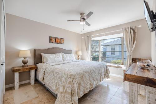 a white bedroom with a bed and a window at Villa Thunderbird View, Cape Coral in Cape Coral