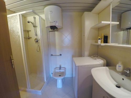 a bathroom with a shower and a toilet and a sink at Appartamento Solaria a Marilleva 1400 in Marilleva