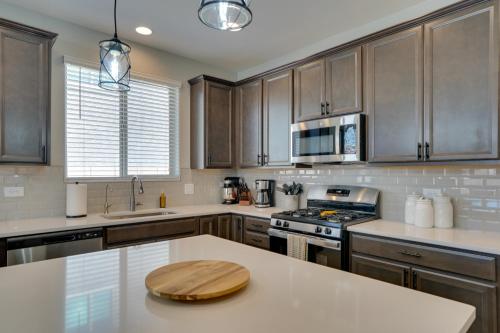 a kitchen with wooden cabinets and a white counter top at Lovely Tucson Home with Private Pool and Fire Pit! in Tucson