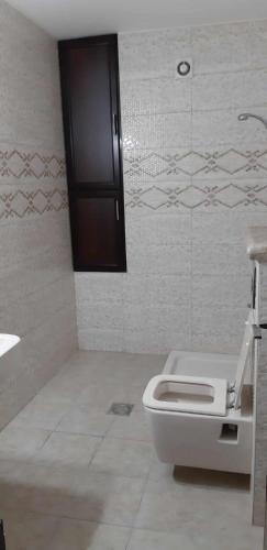 a bathroom with a toilet and a sink at Salah Khamlan Apartments in Nablus