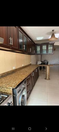 a large kitchen with a washer and dryer in it at Salah Khamlan Apartments in Nablus
