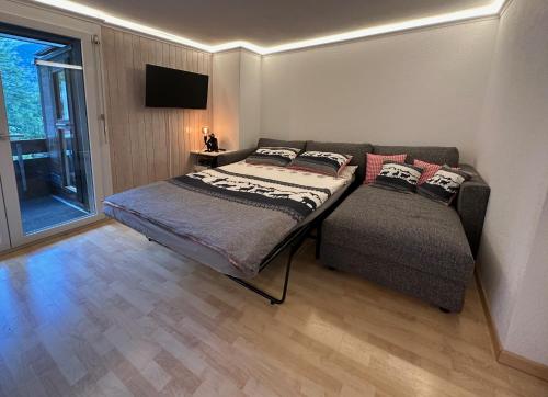a bedroom with a bed and a couch at Chalet Ribi in Grindelwald