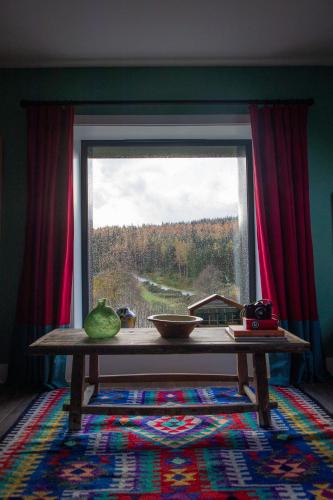a table in front of a window with a view at The Hayloft in Banchory