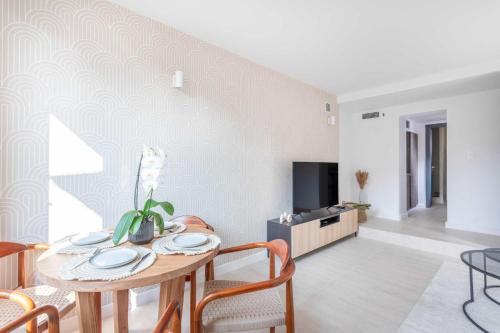 a living room with a table and chairs and a tv at Small private house 4P1BR - Marseille 8th in Marseille