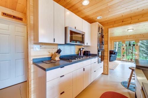 a kitchen with white cabinets and a counter top at Spacious Soldotna Home with Mackey Lake Views! in Soldotna