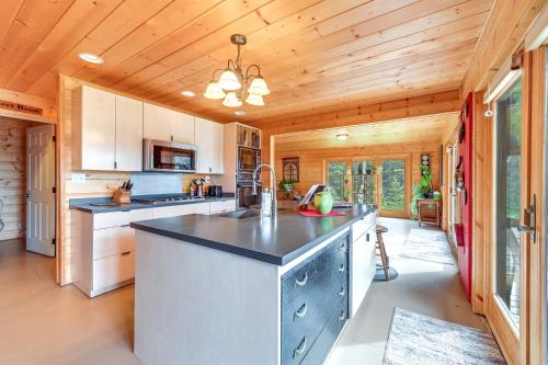 a kitchen with a large island in a cabin at Spacious Soldotna Home with Mackey Lake Views! in Soldotna