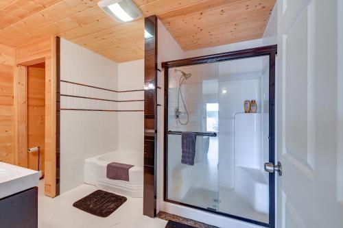 a bathroom with a shower with a glass door at Spacious Soldotna Home with Mackey Lake Views! in Soldotna