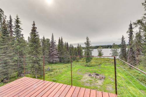 a deck with a view of a field of grass at Spacious Soldotna Home with Mackey Lake Views! in Soldotna