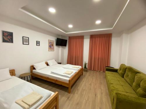 a hotel room with two beds and a couch at Green River in Konjic