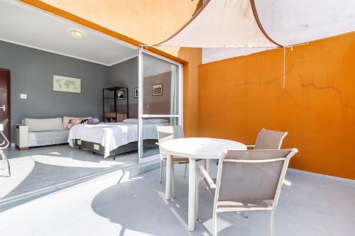 a room with a table and a bed and a bedroom at Studio 9 Pinheiros by OBA in São Paulo