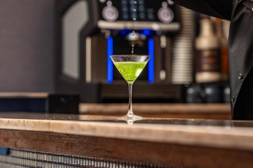 a martini glass sitting on top of a bar at Hotel Westport Kansas City, Tapestry Collection by Hilton in Kansas City