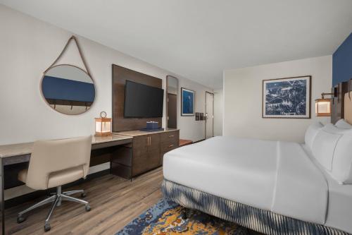 a bedroom with a bed and a desk with a computer at Hotel Westport Kansas City, Tapestry Collection by Hilton in Kansas City
