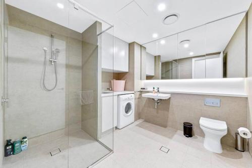 a bathroom with a shower and a toilet and a sink at New Amazing Park City high level APT in Sydney