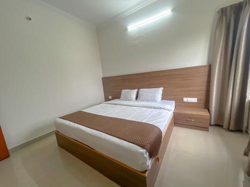 a bedroom with a bed in a room at Hotel Elite by Agira- Spacious Apartments with Balcony in Yelahanka