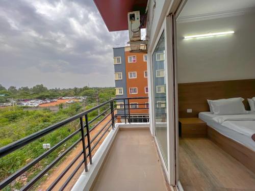a balcony of a apartment with a bed at Hotel Elite by Agira- Spacious Apartments with Balcony in Yelahanka