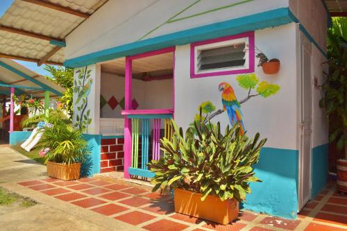 a colorful house with a parrot painted on it at Casa del Bosque in Trujillo