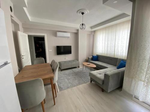 a living room with a couch and a table at 2+1 SÜPER EŞYALI KİRALIK DAİRE in Dalaman
