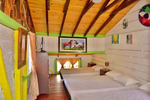 a room with three beds in a house at Casa del Bosque in Trujillo