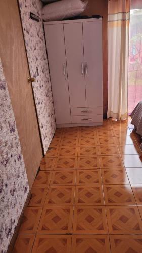 a room with a wooden floor and a closet at Cabaña Tongariki in Hanga Roa