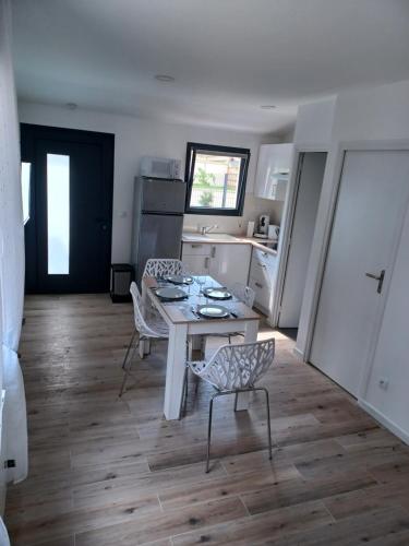 a kitchen with a table and chairs in a room at Petite maison cocooning aux portes de Paris in Orly
