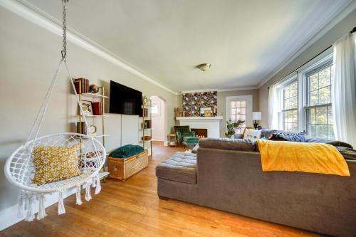 a living room with a couch and a swing at Historic Detroit Bungalow Pet and Family Friendly in Detroit