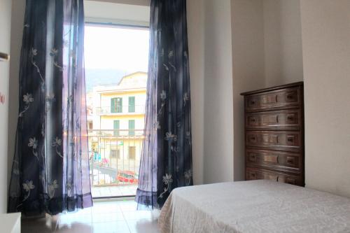 a bedroom with a bed and a large window at Uno Spettacolo Della Natura in San Lucido