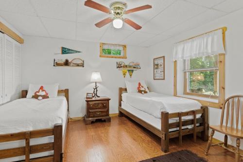 a bedroom with two beds and a ceiling fan at Moonbeams & Fireflies in Chestertown