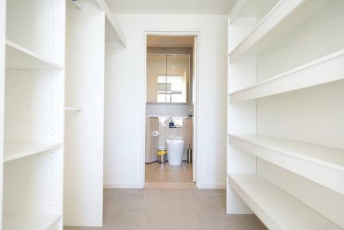 um corredor com prateleiras brancas numa casa em Stunning 2 bedroom APT in Wentworth point em Sidney