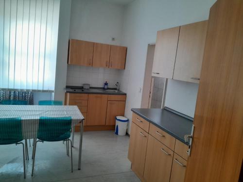 a kitchen with wooden cabinets and a table and chairs at Waldshut Stadt Ferien Wohnung in Waldshut-Tiengen