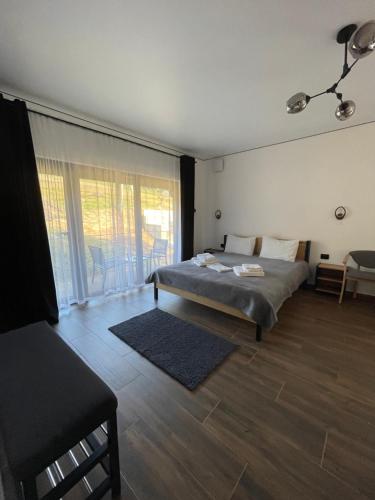 a bedroom with a bed and a large window at Шишка in Bukovel