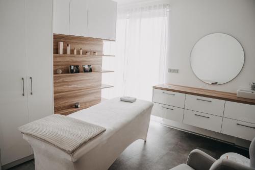 Dieses weiße Zimmer verfügt über einen Schminktisch und einen Spiegel. in der Unterkunft Apartmán Ústí in Hranice