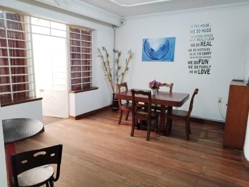a dining room with a wooden table and chairs at Casa en Bogotá ubicada en zona central in Bogotá